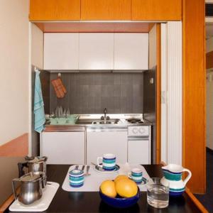 a kitchen with a counter with bowls of fruit on it at Residence Viserba in Milan