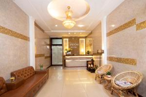 a lobby of a hotel with a couch and chairs at Vilion Central Hotel & Spa in Ho Chi Minh City