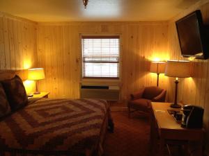 a bedroom with a bed and a desk and a window at Reid Ridge Lodge in Blue Ridge