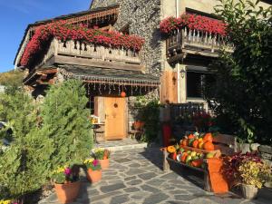 a building with a bunch of fruits and vegetables in front of it at La Belle Josephine in Bourg-Saint-Maurice