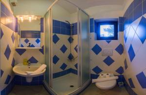 a bathroom with a shower and a sink and a toilet at The Sea House Apartments in Vis