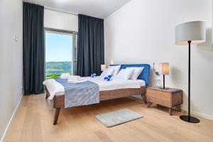 a bedroom with a bed and a large window at Motovun Villas in Motovun +85 photos