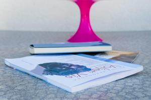 a book and a vase on top of a table at The Sea House Apartments in Vis