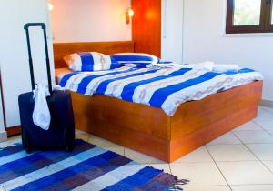a bedroom with a bed and a suitcase at The Sea House Apartments in Vis