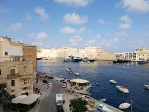 a view of a city with boats in the water at Entire Senglea Seaview Town house in Senglea