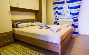 a bedroom with a bed with towels on it at The Sea House Apartments in Vis