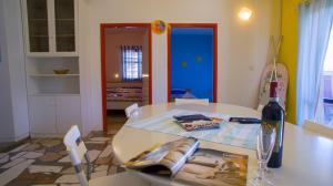 a white table with a bottle of wine on it at The Sea House Apartments in Vis