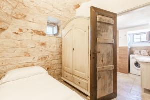 Postel nebo postele na pokoji v ubytování Trullo del Mandarino con piscina