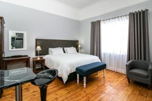 Postel nebo postele na pokoji v ubytování Victorian Square Guesthouse