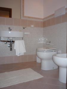 a bathroom with a toilet and a sink at Brezza Marina in San Vito lo Capo