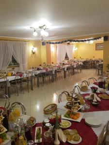 a banquet hall with tables and chairs with food on them at Dom Wypoczynkowy Tulipan in Zakopane