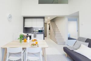 a kitchen and living room with a table and chairs at Spot Apartments Tikkurila in Vantaa