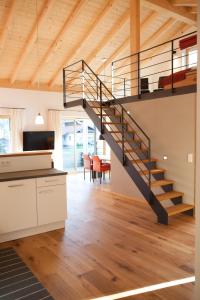 a kitchen and living room with a staircase in a house at Haus FreiRaum in Fischen