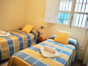 Łóżko lub łóżka w pokoju w obiekcie Apartamento con encanto en el Barrio de Santa Cruz