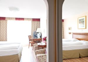 Postel nebo postele na pokoji v ubytování Hotel Alpenkrone