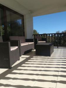 a patio with chairs and tables on a balcony at Vivienda Vacacional La Seronda in Ribadesella