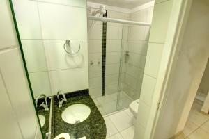 a small bathroom with a shower and a toilet at Hotel Vela Azul in Balneário Camboriú