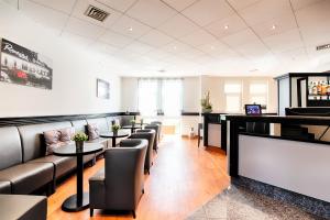 a bar with couches and tables in a restaurant at ACHAT Hotel Hockenheim in Hockenheim