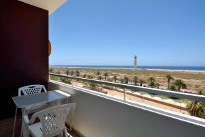 a room with a balcony with a view of the beach at The Real Casa Atlantica Morro Jable By PVL in Morro del Jable