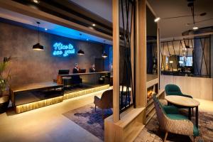 a lobby of a hotel with a desk and a bar at Leonardo Hotel London Croydon - formerly Jurys Inn in Croydon