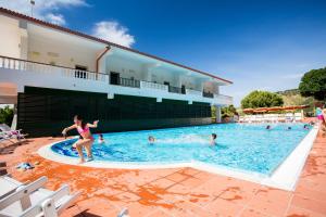 a group of people swimming in a swimming pool at Hotel Santa Lucia in Parghelia