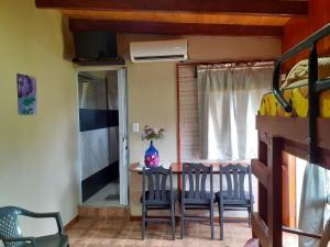 a room with a table and chairs and a bed at Hospedar in Puerto Rico