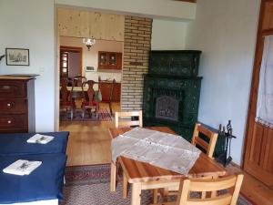 a living room with a table and a fireplace at Garábi Udvarház in Garáb