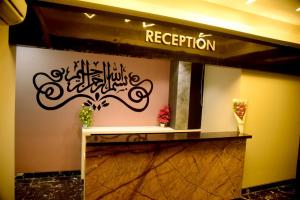 a lobby with a sign that says reception at CHARYANA HOTEL AC DORMITORY in Ahmedabad