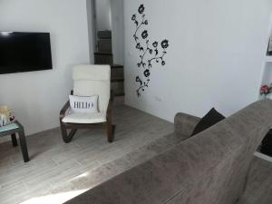a living room with a couch and a chair at CASA PURICA in Frigiliana