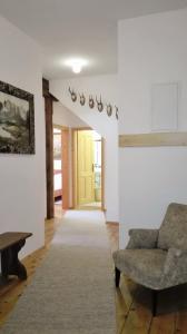 a living room with a couch and a yellow door at Apartments Stegmühle in Mauterndorf