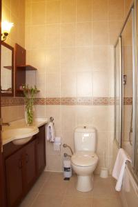 a bathroom with a toilet and a sink at Bacahan Hotel in Altınoluk