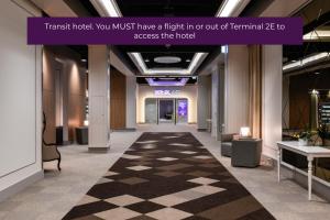 a large room with a large clock on the wall at YOTELAIR Paris CDG - Transit Hotel - Terminal 2E in Roissy-en-France