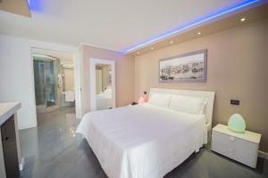 a white bedroom with a large white bed and a window at Cristal Hotel Palermo in Palermo +80 photos