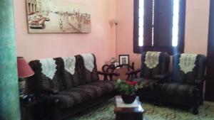 a living room with two leather couches and a table at Casa Colonial La Terraza in Havana