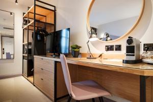 a kitchen with a desk with a mirror and a chair at The Fox & Goose Hotel in London