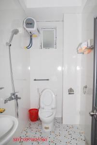 a white bathroom with a toilet and a sink at Quynh Yen Hotel in Ha Long +62 photos