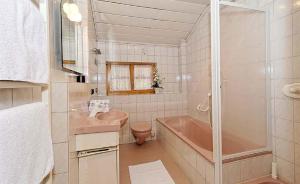 a bathroom with a pink tub and a sink at Ferienhof Scholz in Spiegelau +20 photos