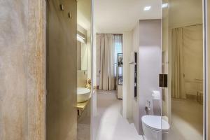 a bathroom with a toilet and a sink and a mirror at Residenza d'Epoca Le Aquile in Siena