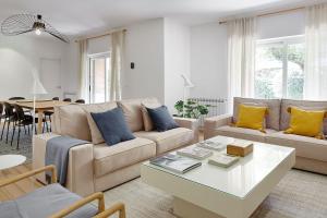 a living room with a couch and a table at ATeRIAN VILLA ARESTI in Zarautz