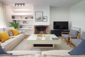 a living room with a couch and a coffee table at ATeRIAN VILLA ARESTI in Zarautz