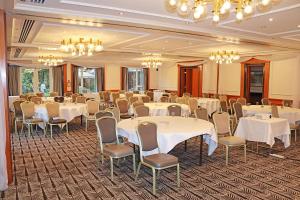 a banquet room with white tables and chairs and chandeliers at Fredrick's Hotel Restaurant Spa in Maidenhead +56 photos
