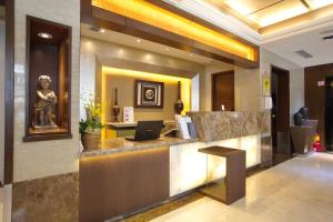 a lobby of a hotel with a laptop on a counter at Shin Yuan Celeb Metro Hotel in Hsinchu City