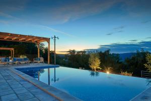 a swimming pool with a view of the mountains at Motovun Villas in Motovun