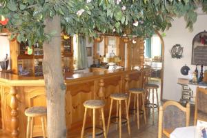 a bar in a restaurant with stools at Isselhorster Landhaus in Gütersloh