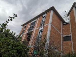 a brick building with windows on the side of it at Guesthouse Luisella in Cagliari