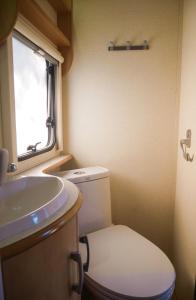 a small bathroom with a toilet and a sink at Nice Nite Campervans in Phra Nakhon Si Ayutthaya