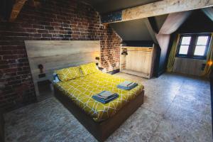 a bedroom with a bed in a brick wall at The Loft Sasco Apartments in Blackpool