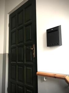 a black door with a television on a shelf at Apartament Starówka in Zielona Góra +12 photos