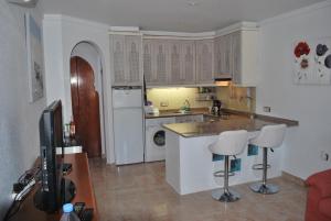 a kitchen with a counter and two bar stools at Casa Grace Naturist Apartment Vera in Vera