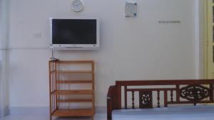 a living room with a flat screen tv on a wall at Homestay Nam Dong in Hanoi